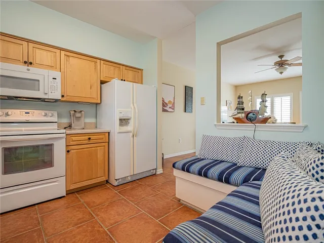 a kitchen with a refrigerator and a stove top oven