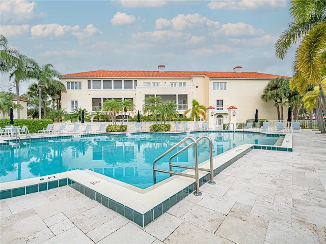 a view of swimming pool with a bench and tables