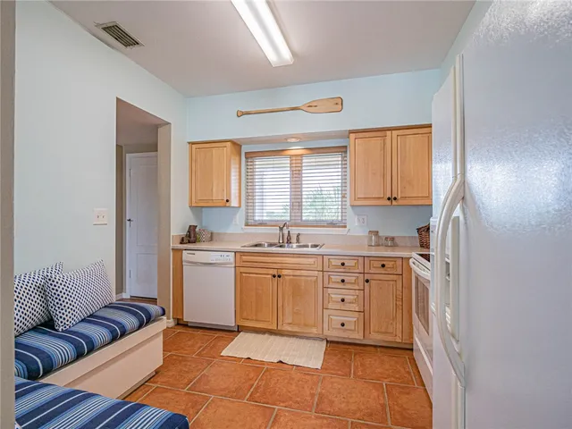 a kitchen with a stove a sink and a refrigerator