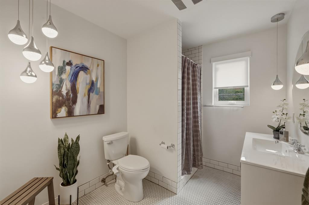 2320 Chart Drive Dallas, TX 75228 - Photo 14 of 34 a bathroom with a toilet sink and mirror