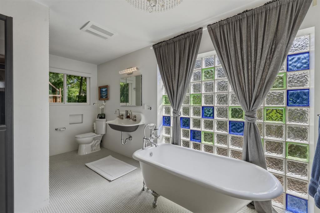 2320 Chart Drive Dallas, TX 75228 - Photo 17 of 34 a bathroom with a sink a toilet a mirror and shower