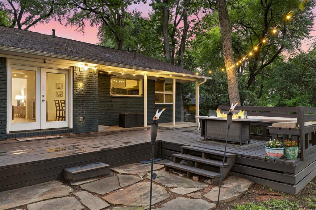 2320 Chart Drive Dallas, TX 75228 - Photo 26 of 34 a view of a patio with table and chairs potted plants and a large tree