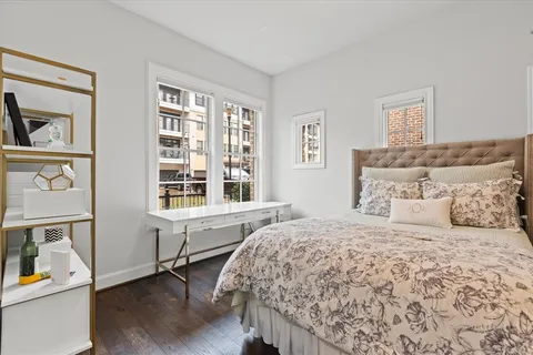a bedroom with a large bed and a window