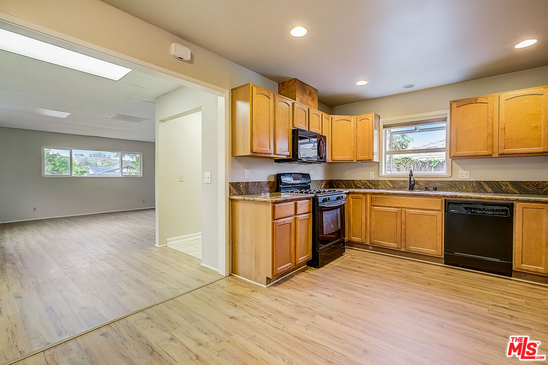 1817 Rolling Hills Drive Fullerton, CA 92835 - Photo 12 of 29 a kitchen with stainless steel appliances granite countertop a stove a sink and a microwave