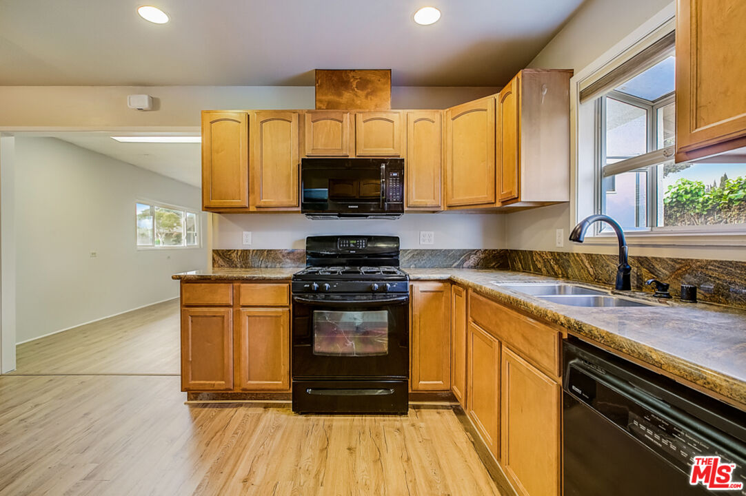 1817 Rolling Hills Drive Fullerton, CA 92835 - Photo 13 of 29 a kitchen with stainless steel appliances granite countertop a stove a sink and a microwave