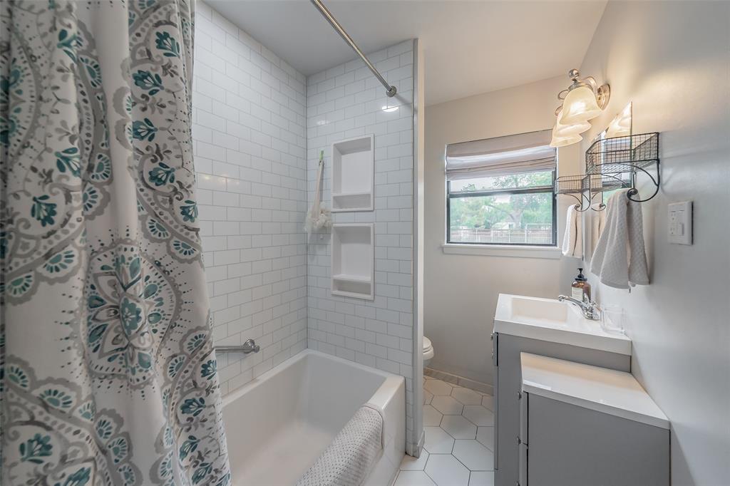 1802 Keneipp Road Carrollton, TX 75006 - Photo 10 of 22 Bathroom featuring white subway tile in the shower and white hexagon tile flooring