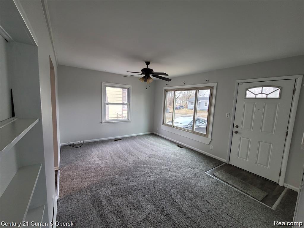 25906 Lehigh Street Inkster, MI 48141 - Photo 2 of 9 Recessed shelving, ceiling fan, and carpeted flooring