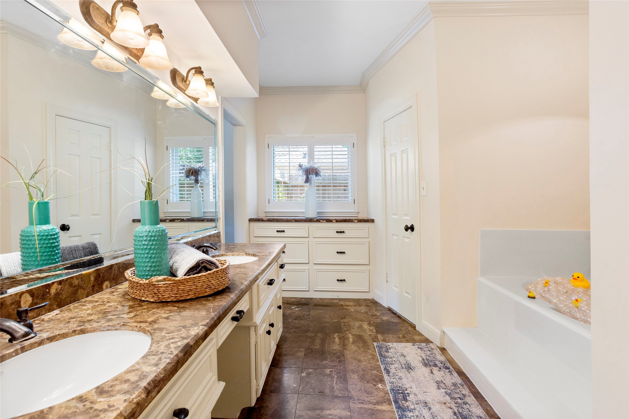 22015 Fielder Drive Katy, TX 77450 - Photo 21 of 38 a bathroom with a granite countertop sink a mirror a vanity and a bathtub