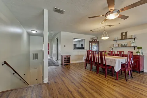 a view of a dining room with furniture and wooden floor