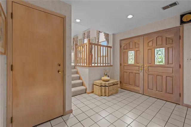a living room with furniture a chandelier and a table