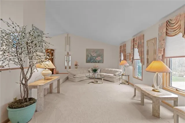 a view of a dining room with furniture a chandelier and wooden floor