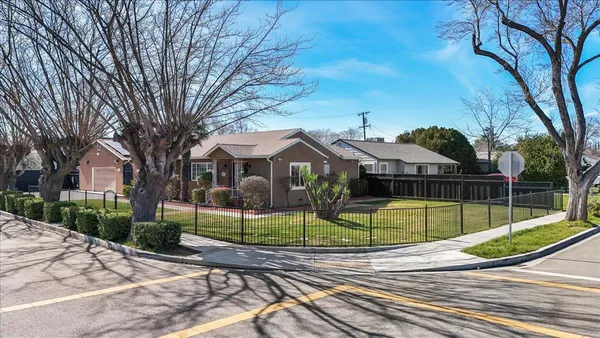 a view of a park with iron fence