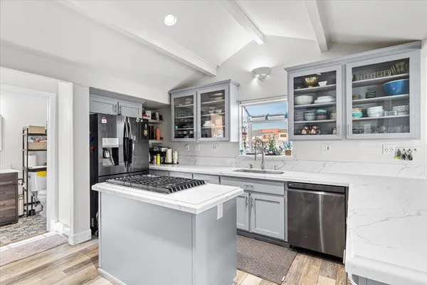 a kitchen with a sink stove and refrigerator