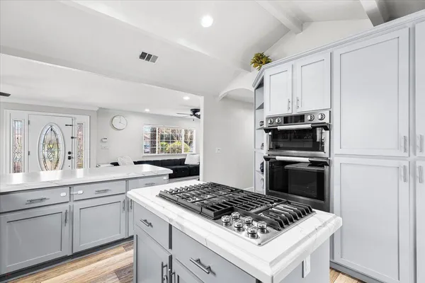 a white kitchen with a stove and a refrigerator