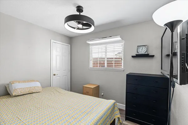 a bedroom with a bed and a chandelier