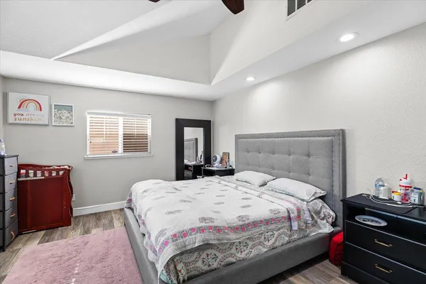 a bedroom with a bed and dresser