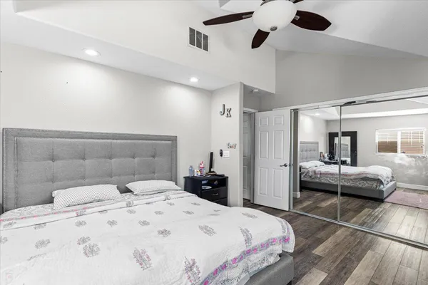 a bedroom with a bed and ceiling fan