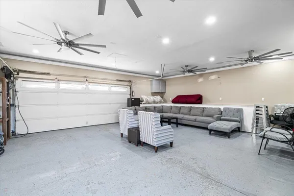a living room with furniture and a ceiling fan