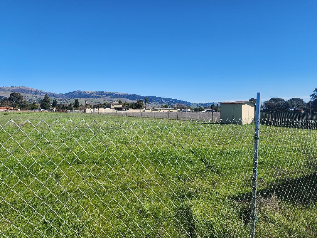 a view of a field with an ocean view