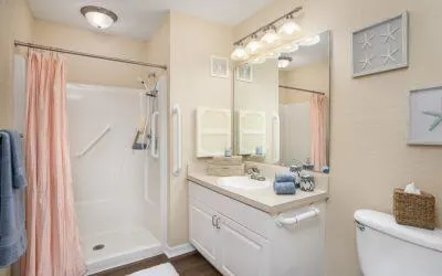 a bathroom with a double vanity sink mirror and shower