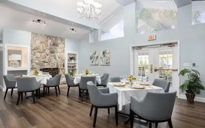a dining room with furniture a chandelier and wooden floor
