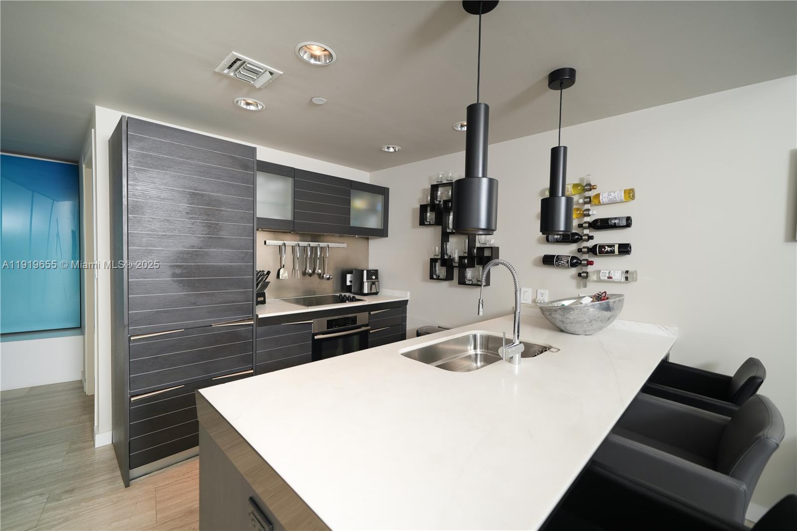 200 Biscayne Blvd Way, Unit 3906 Miami, FL 33131 - Photo 12 of 26 a kitchen with stainless steel appliances a sink a stove a refrigerator and cabinets