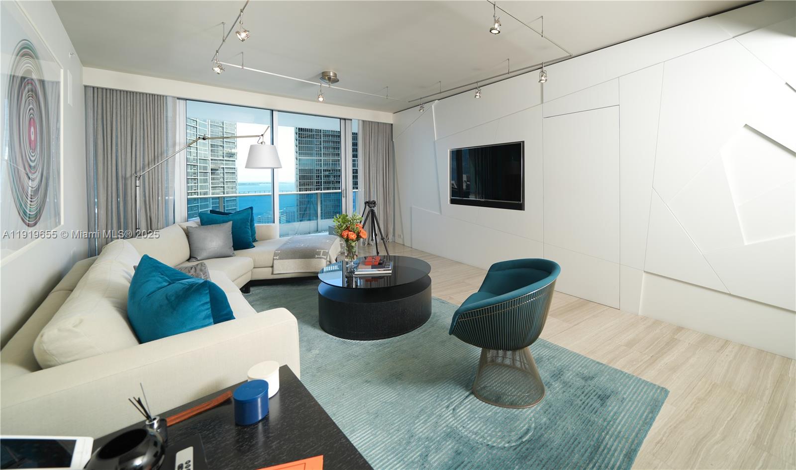 200 Biscayne Blvd Way, Unit 3906 Miami, FL 33131 - Photo 13 of 26 a living room with furniture and a flat screen tv