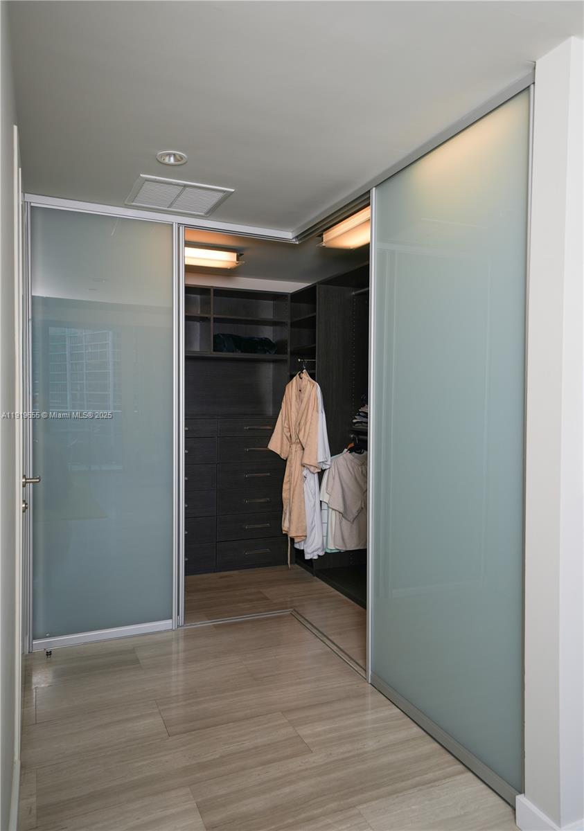 200 Biscayne Blvd Way, Unit 3906 Miami, FL 33131 - Photo 16 of 26 a view of bedroom with wooden floor and window