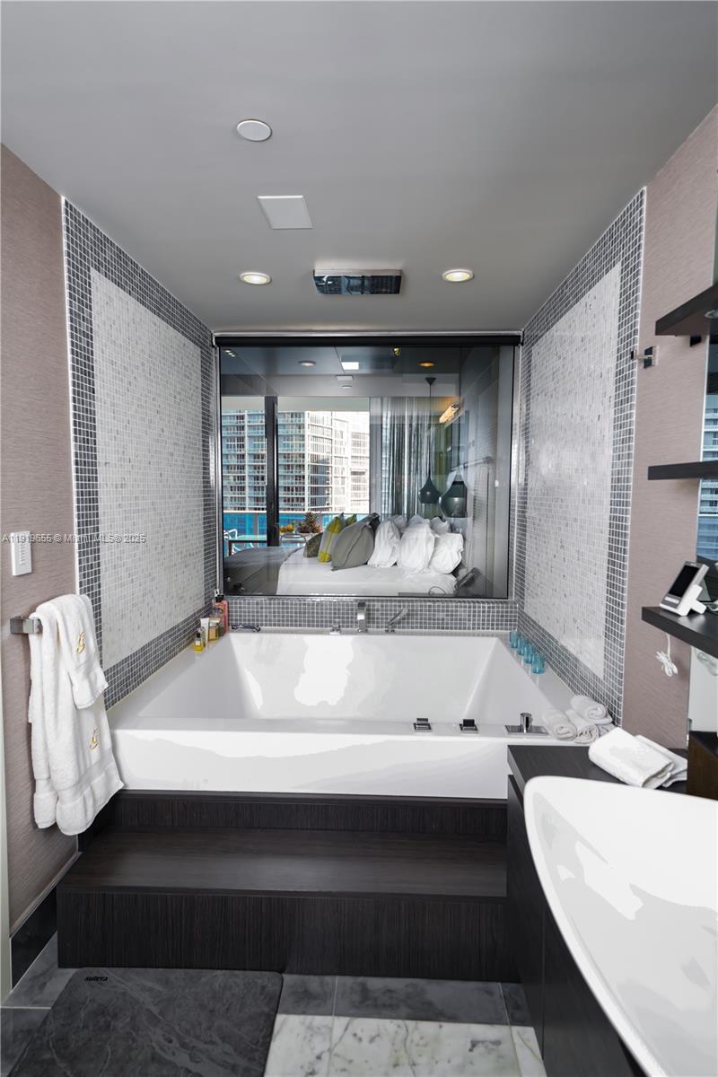 200 Biscayne Blvd Way, Unit 3906 Miami, FL 33131 - Photo 18 of 26 a bathroom with a bathtub and a sink