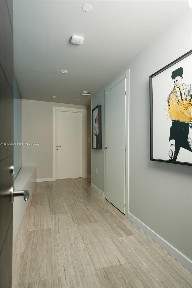 200 Biscayne Blvd Way, Unit 3906 Miami, FL 33131 - Photo 22 of 26 an empty room with wooden floor and closet