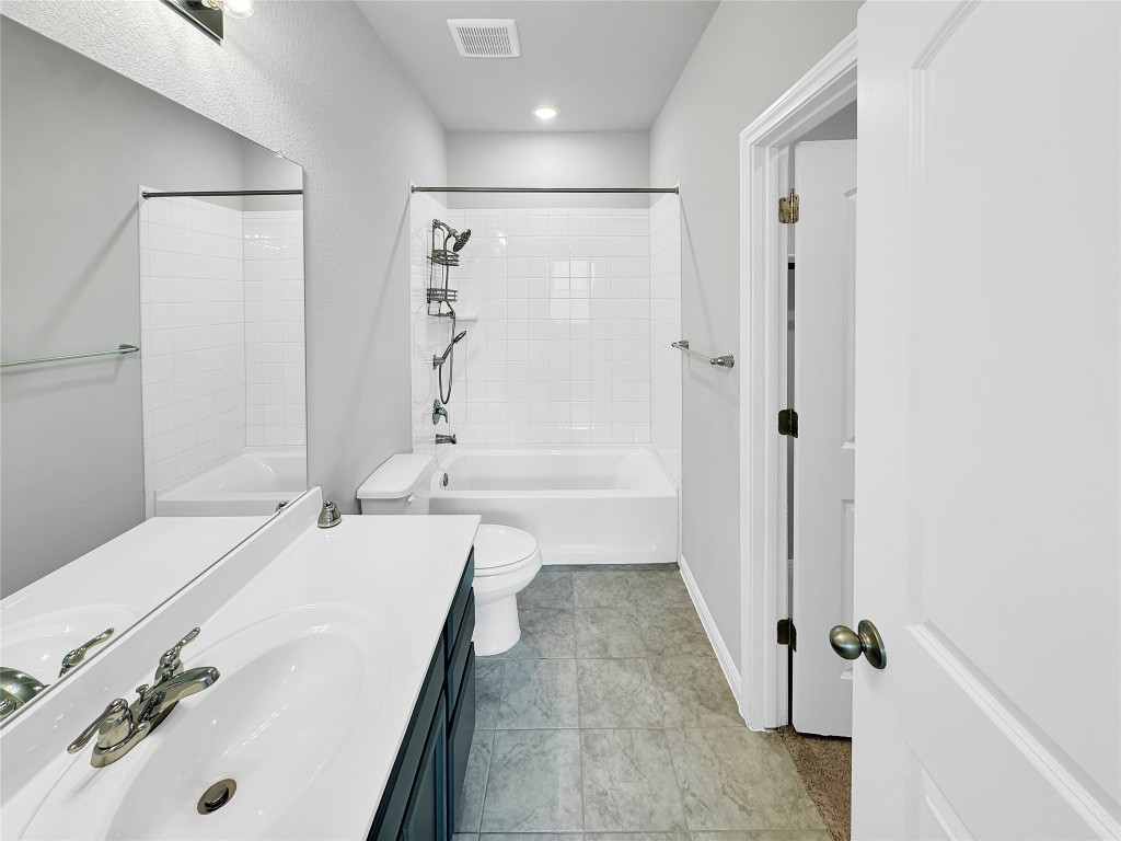 2437 Roosevelt Road Leander, TX 78641 - Photo 18 of 35 Bathroom featuring shower / tub combination and vanity