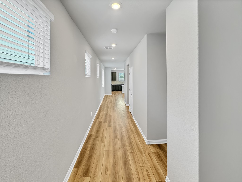2437 Roosevelt Road Leander, TX 78641 - Photo 2 of 35 A grand entry with gorgeous hallway lit up with natural light and plenty of recess can lighting.