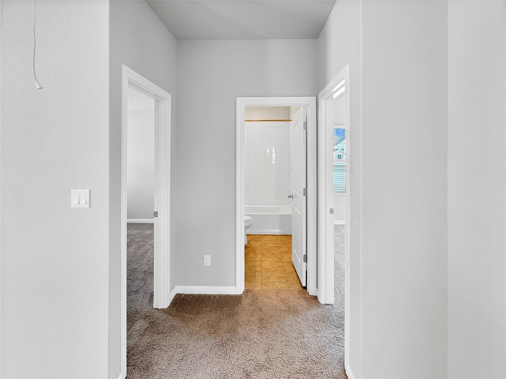2437 Roosevelt Road Leander, TX 78641 - Photo 22 of 35 Corridor looking towards the upstairs secondary bedrooms with the full bathroom in the middle.