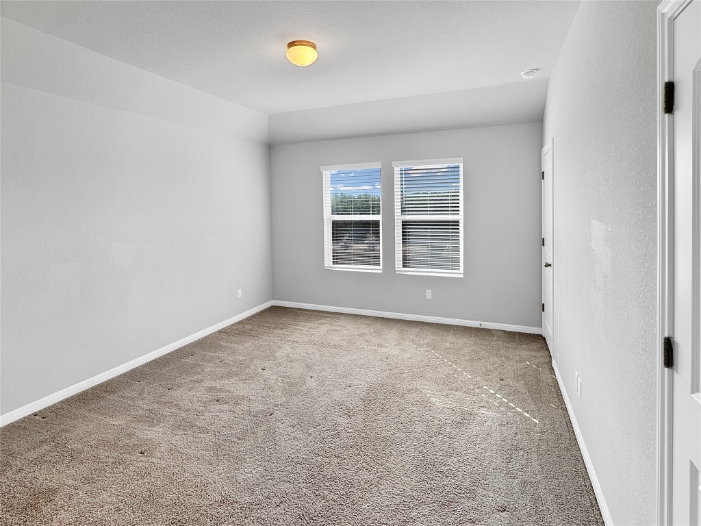 2437 Roosevelt Road Leander, TX 78641 - Photo 29 of 35 Primary Bedroom upstairs with lovely views to the greenbelt!