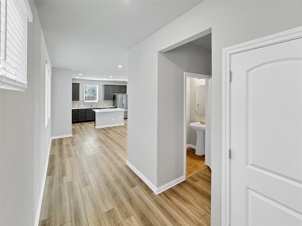 2437 Roosevelt Road Leander, TX 78641 - Photo 3 of 35 After passing the garage entry you come upon the half bathroom, views into kitchen.