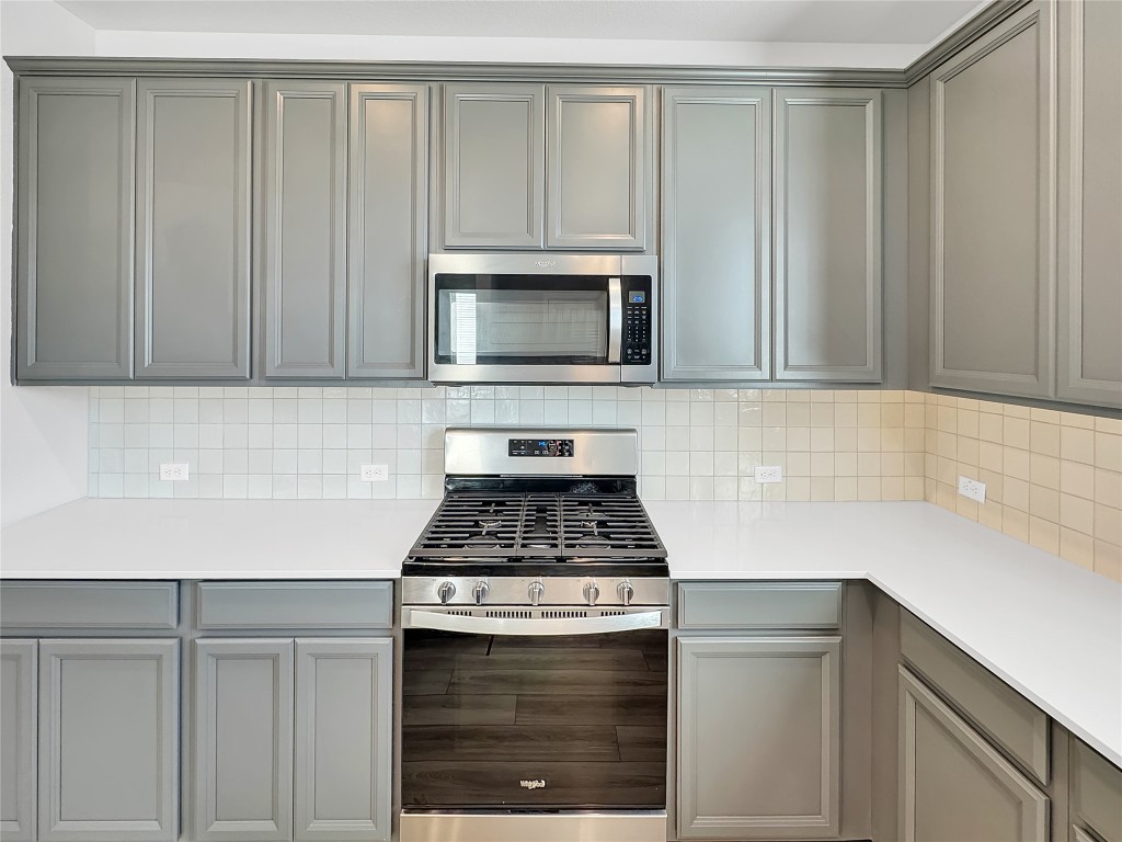 2437 Roosevelt Road Leander, TX 78641 - Photo 9 of 35 Gas stove with microwave overhead.