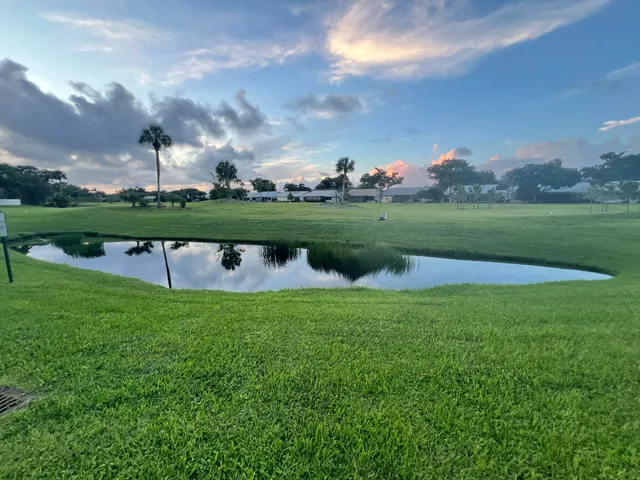 a view of a lake with a yard in the back