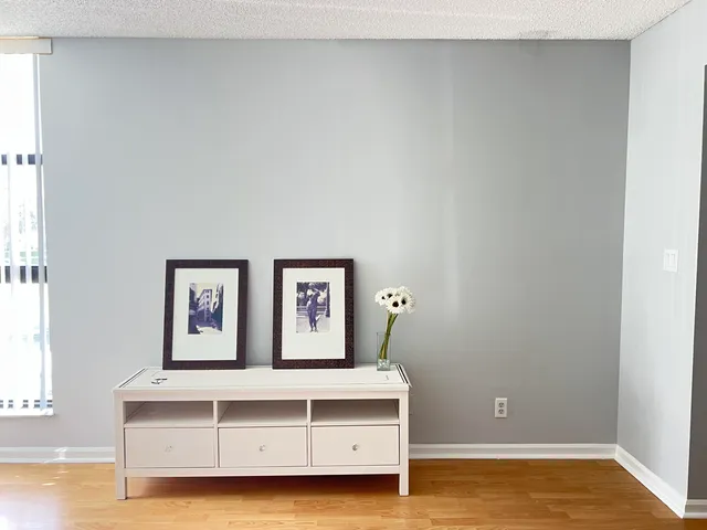 a view of room with window and wooden floor