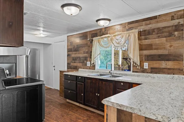 a kitchen with a sink and large window