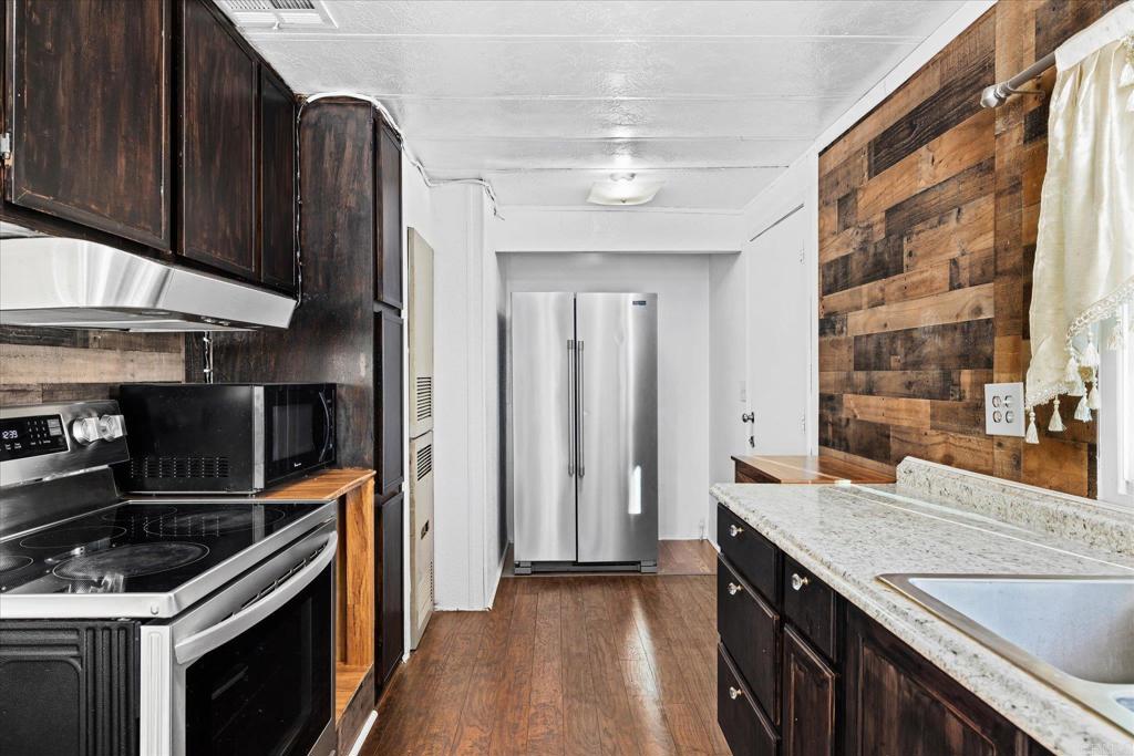 59063 Reynolds Way Anza, CA 92539 - Photo 8 of 34 a kitchen with stainless steel appliances granite countertop a stove and a refrigerator