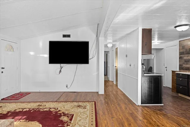 a living room with a flat screen tv and a rug