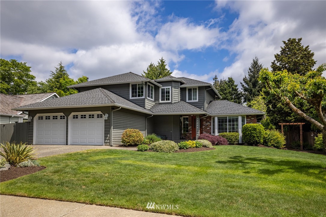 24229 15th Place Southeast Bothell, WA 98021 - Photo 1 of 40 a front view of a house with garden