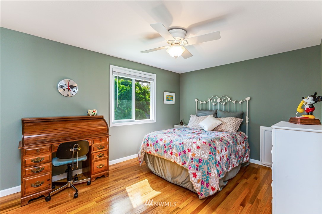24229 15th Place Southeast Bothell, WA 98021 - Photo 22 of 40 a bedroom with a bed and a chandelier