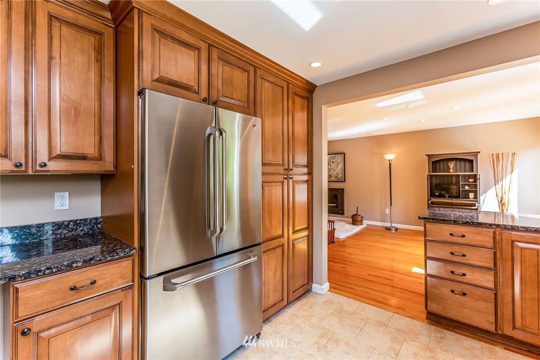 24229 15th Place Southeast Bothell, WA 98021 - Photo 10 of 40 a kitchen with stainless steel appliances granite countertop a refrigerator and a stove top oven