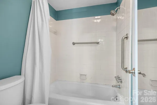 a bathroom with a granite countertop sink a large mirror and a shower