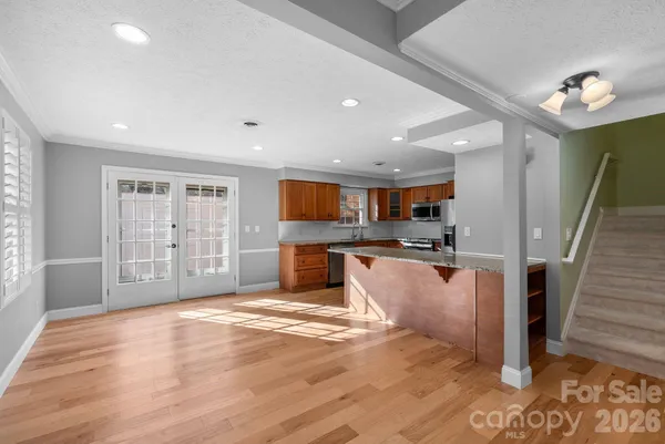 a kitchen with stainless steel appliances kitchen island granite countertop a sink and cabinets