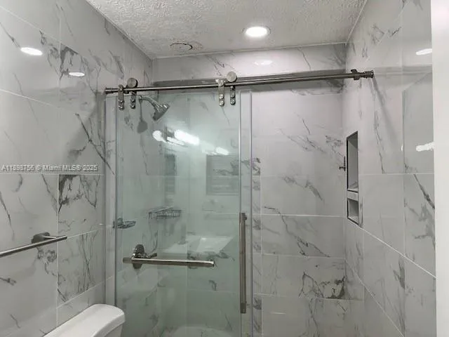 a bathroom with a shower and toilet