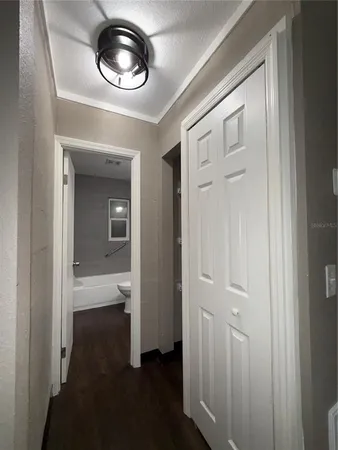 a view of a hallway with wooden floor
