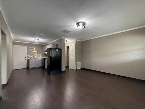 a view of a livingroom with wooden floor and closet