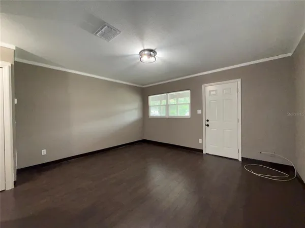 a view of an empty room with a window